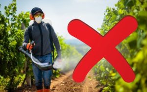 An 'X' marked on image of a person spraying pesticides